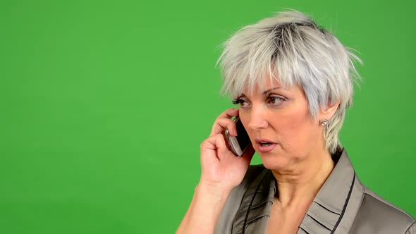 Business Middle Aged Woman Phone (Serious Face) - Green Screen - Studio - Closeup alt