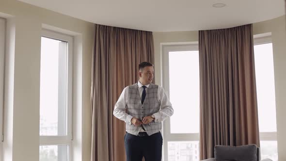 Buttoning Jacket with Hands Close Up Man in Suit Fastens Buttons on His Jacket Preparing to Go Out alt