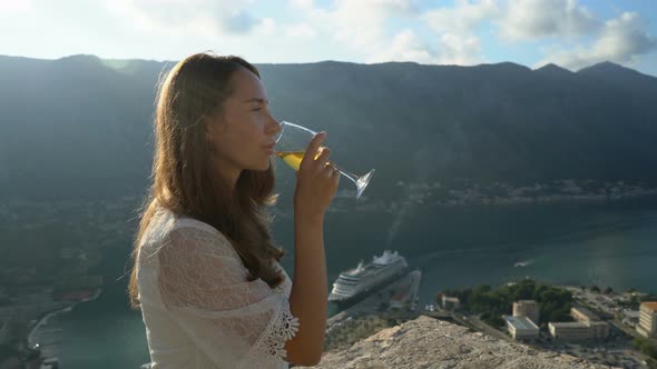 Girl Drinks Wine While Being Above Kotor