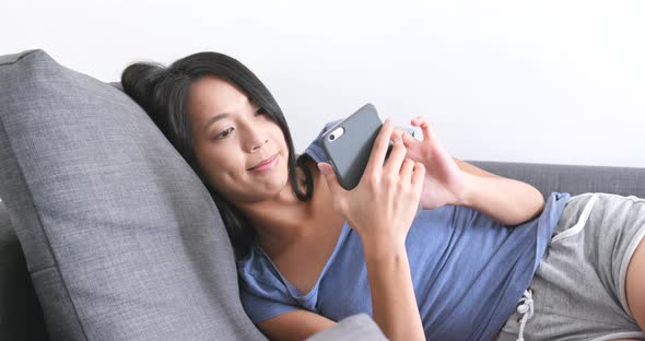 Woman use of smart phone at home  alt