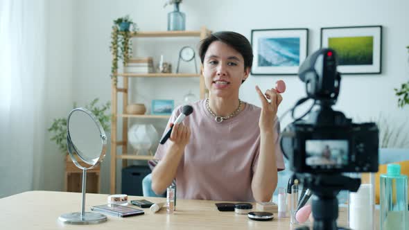 Professional Makeup Artist Recording Video Applying Decorative Cosmetics and Speaking to Camera alt