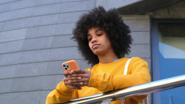 Beautiful Woman Using Phone Walking On Street. Portrait Of Stylish Smiling Business Woman alt