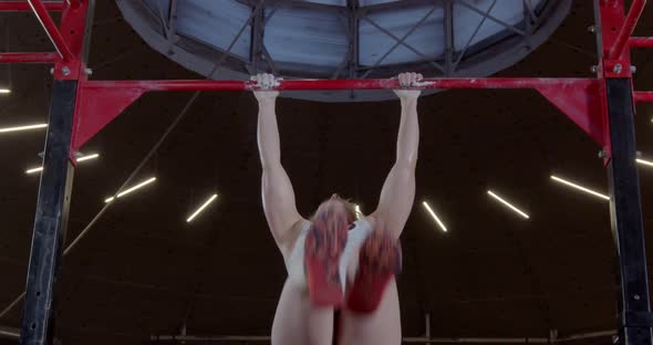 Mature Muscular Woman Doing a Pullup an Upperbody Strength Exercise Modern Gym alt