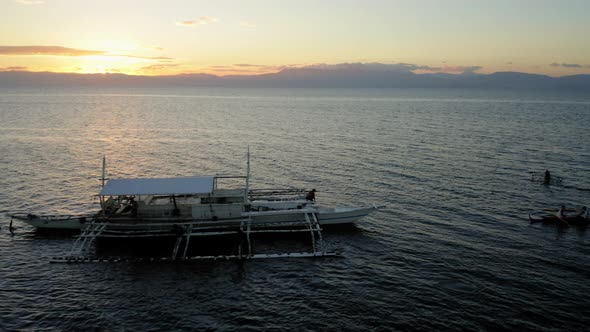 Aerial view of a Spider boat in Moalboal Beach at the sunset, Cebu, Philippines alt