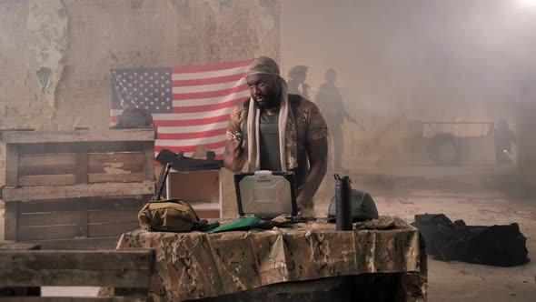 Dark-skinned Soldier Angry with Bad News on Radio alt