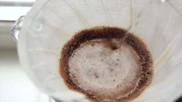 Pouring Water Into the Filter with Coffee Brewing Alternative Coffee