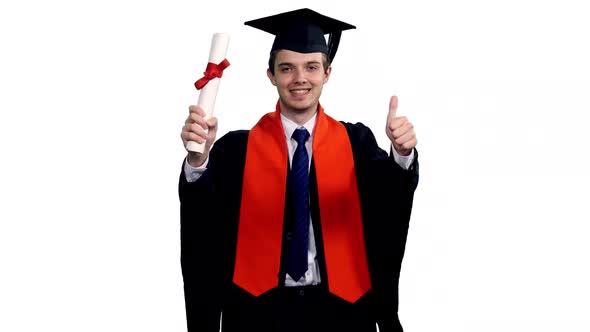Happy Male Graduate Walking With Certificate And Showing Thumbs Up