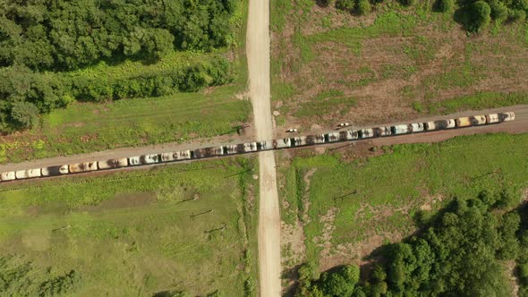 Aerial Top View of Old Freight Train with Many Cars Moving on Country Area