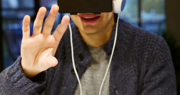 Man using virtual reality headset at home alt