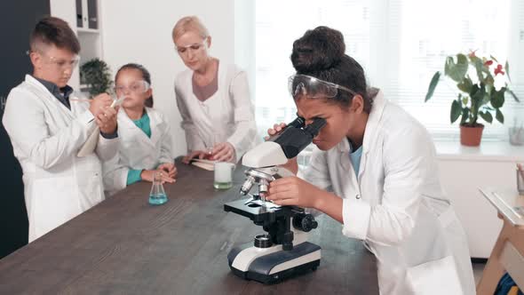 Smart Schoolchildren Doing Research in Science Class alt