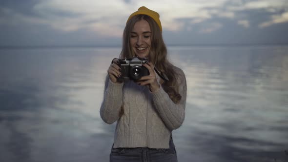 Portrait of Cheerful Young Caucasian Woman Taking Photos on Camera Standing on River Bank on alt