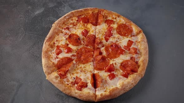 whole fresh round pizza with pepperoni and mozzarella cheese rotating