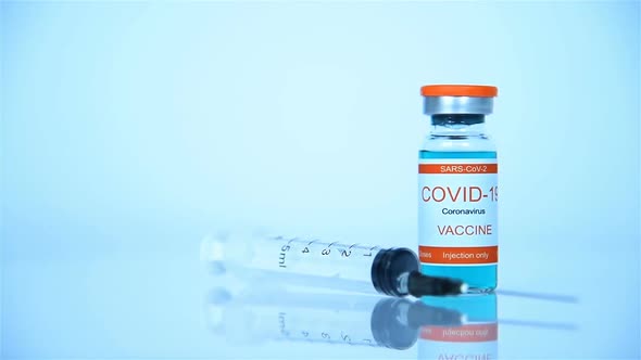 Glass Bottle With Vaccine Covid-19 And Syringe Injection.