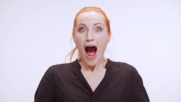 Surprised Young Caucasian Woman with Colored Orange Hair Standing in White Background in Dark Brown alt