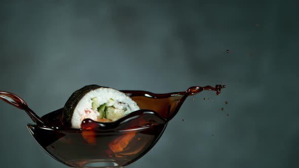 Super Slow Motion Shot of Fresh Sushi Falling Into Soy Sauce at 1000Fps. alt