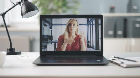 Laptop with Blond Woman on Screen