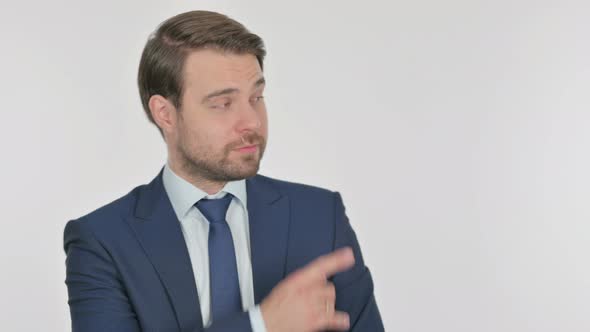Young Businessman Pointing on Side on White Background alt