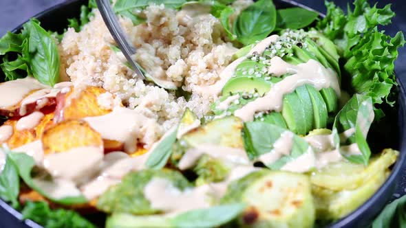 Quinoa salad with baked zucchini, sweet potato, avocado and tahini dressing alt