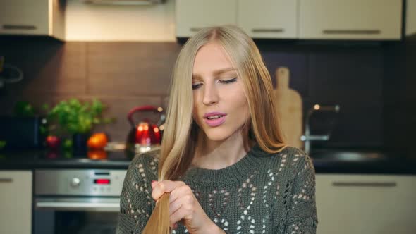 Young Vlogger Combing Hair for Camera. alt