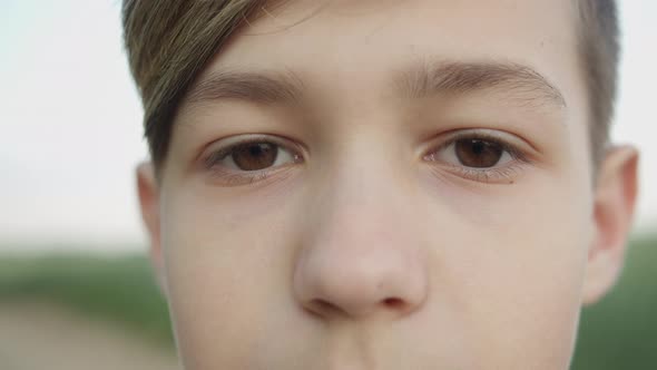 Portrait of a Boy Looking at the Camera and Smiling, Close-up of Eyes alt