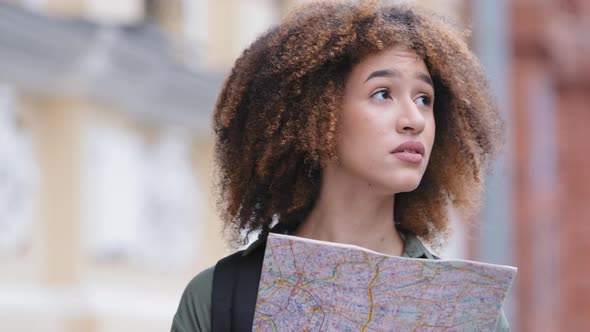 Confused Desperate Young Curlyhaired Black Student Girl Exploring Paper City Map Trying to Get alt