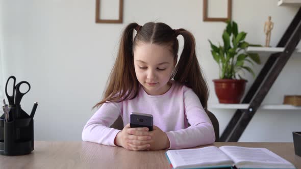 Pupill Obsession Girl From Social Networks and the Internet with a Phone in Her Hands Sitting at a alt
