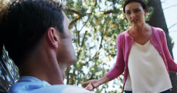 Couple into an argument with each other near car alt