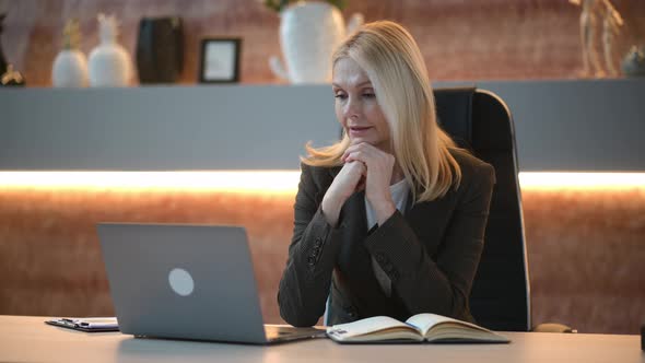 Positive Beautiful Influential Caucasian Mature Woman Top Company Manager Sits in Office Using alt