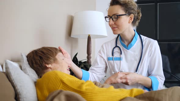 Health Visitor And Senior Woman During Doctor Home Visit.