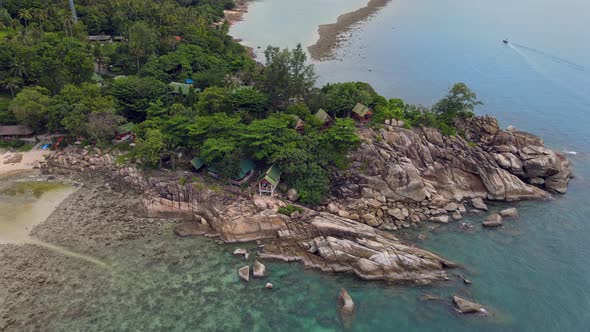 Aerial View of Island Beach with Bungalow and Rocky Coastline at Haad Khom Beach alt