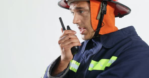 Fireman talking on walkie-talkie against white background 4K 4k, Stock