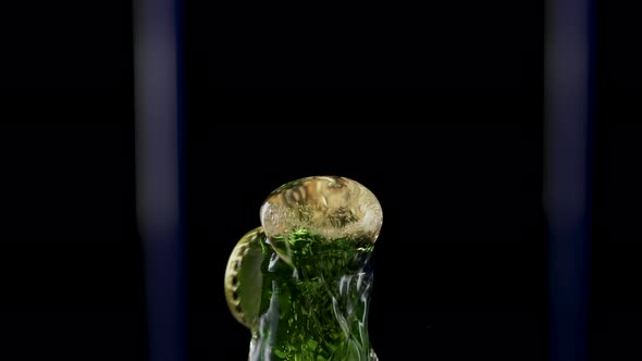 Macro Shot of Cap Popping Out of Green Glass Bottle and Explosion of Splash Carbonated Beer alt