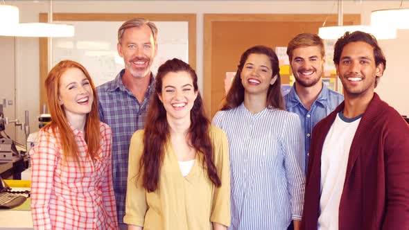 Business colleagues standing together in office alt