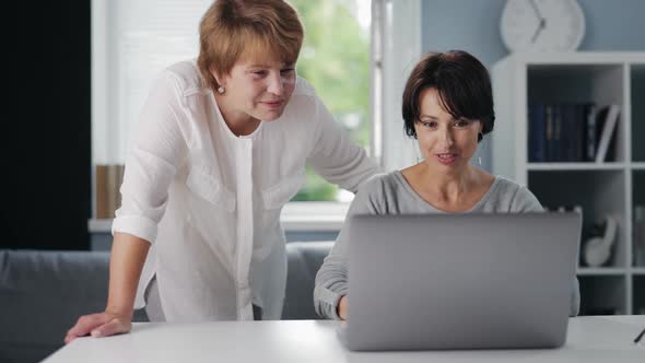 Two Women Using Laptop
