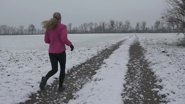 Woman Jogging on Winter Morning in Slow Motion alt