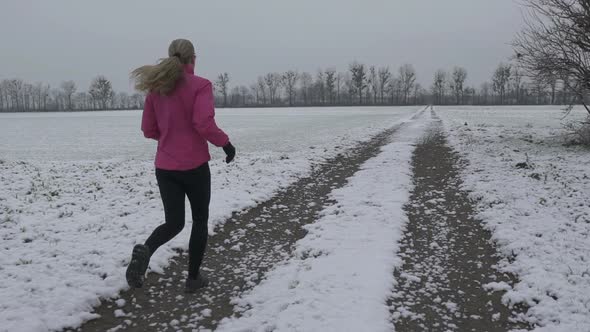 Woman Jogging on Winter Morning in Slow Motion