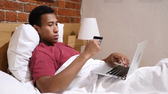 Online Payment Failure, Upset African Man in Bed Trying to Shop Online alt