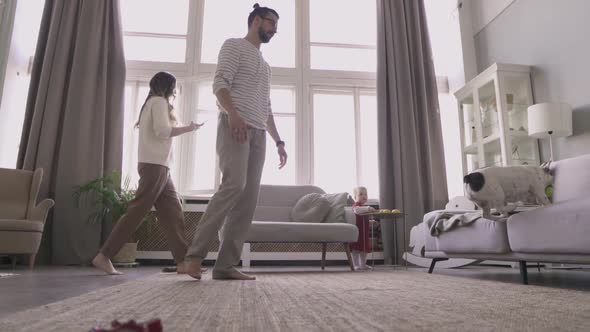 A Handsome Man Unsuccessfully Trying to Catch a French Bulldog alt