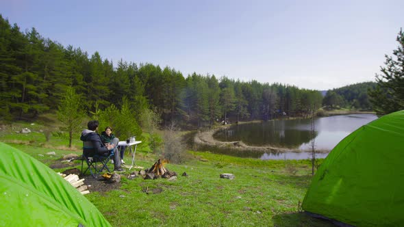 Camping and campfire by the lake. alt