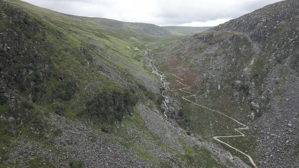 Hiking Trail And Stream Along The Glendalough Valley In County Wicklow, Ireland - aerial drone alt