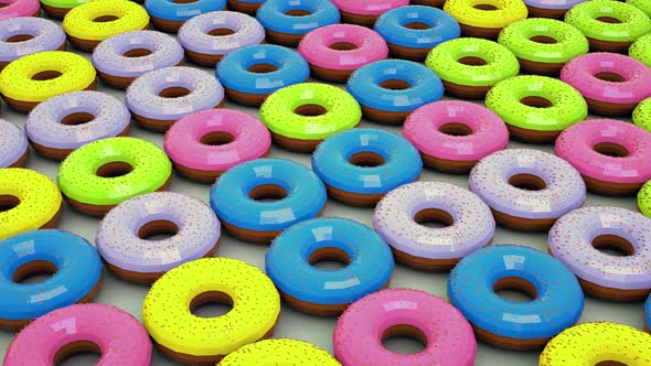 Lots of colored donuts . The camera moves over the background of the donuts