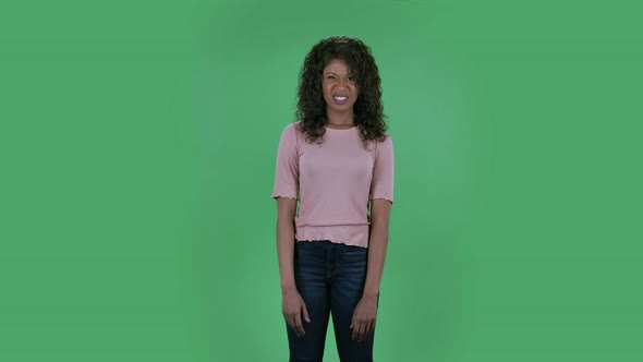 Portrait of Beautiful African American Young Woman Is Looking at Camera in Dislikes. Burning alt