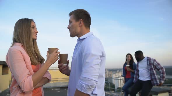 Nice Caucasian Couple Drinking Cocktails and Flirting at Roof Party, Relations