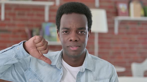 African Man Showing Thumbs Down alt