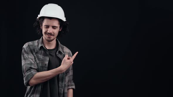 The Charismatic Boy in the White Helmet of the Engineer Points to the Right Says No and Shows the