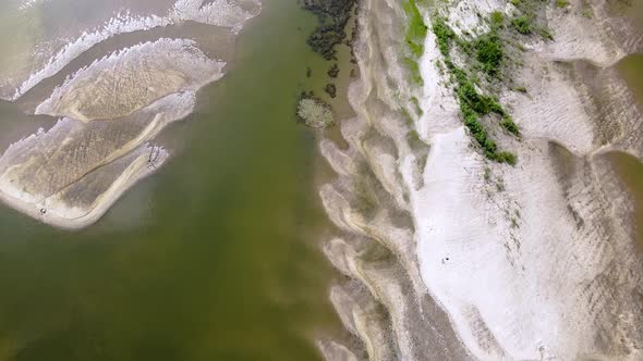 Amazing  sandy island on the river. Big sand dunes under transparent water