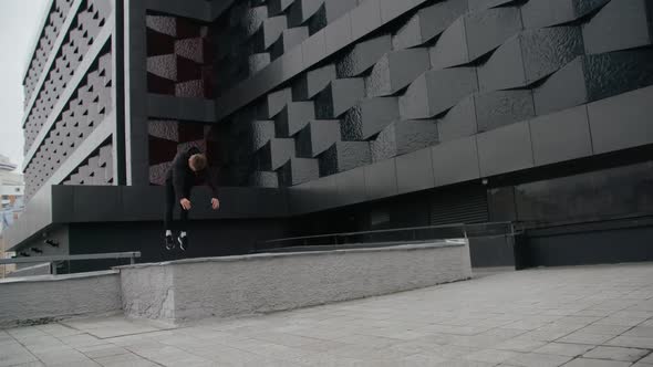 Young Man Does Flips and Jumps Parkour on Modern City Free Running in  Slow Motion alt