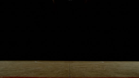 Male basketball player playing in the court alt