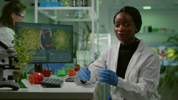 African Scientific Woman Putting Her Medical Glasses alt