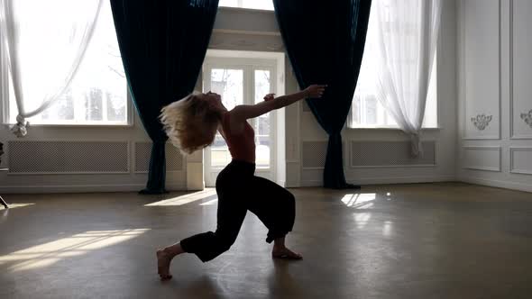 Talented Young Woman is Dancing Alone in Dance Hall Practicing Modern Choreography alt